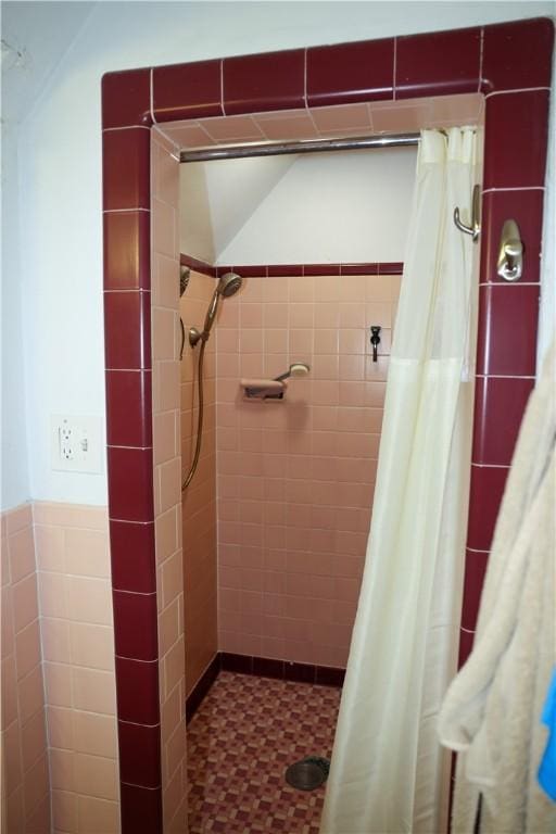 bathroom featuring a stall shower and tile walls