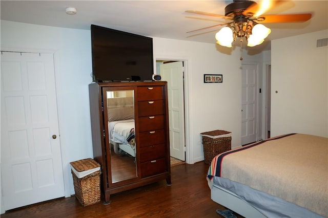 bedroom featuring ceiling fan, visible vents, and dark wood-type flooring