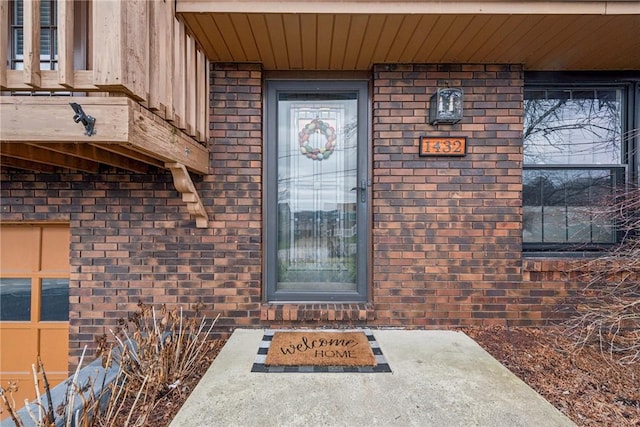 property entrance featuring brick siding
