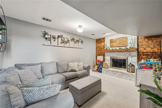 carpeted living area featuring visible vents and a fireplace