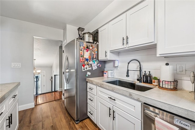kitchen featuring white cabinetry, light countertops, stainless steel appliances, and a sink