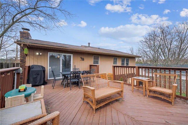 wooden deck featuring grilling area and outdoor dining area
