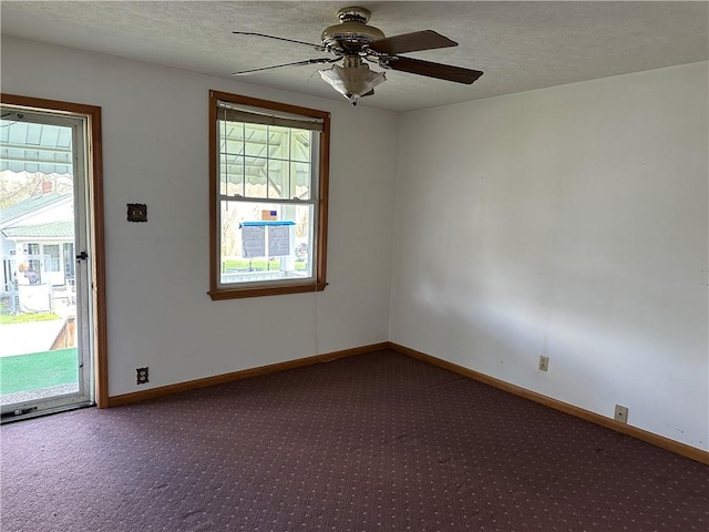 unfurnished room with baseboards, carpet floors, a ceiling fan, and plenty of natural light
