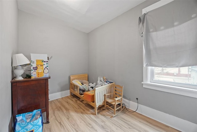 bedroom with baseboards and wood finished floors