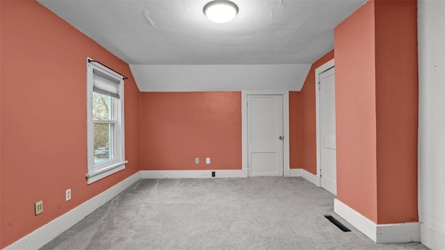 bonus room featuring vaulted ceiling, carpet, and baseboards