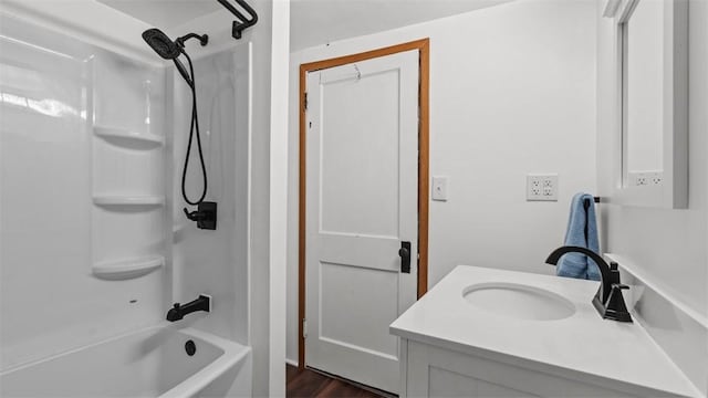 bathroom with shower / bathing tub combination, vanity, and wood finished floors