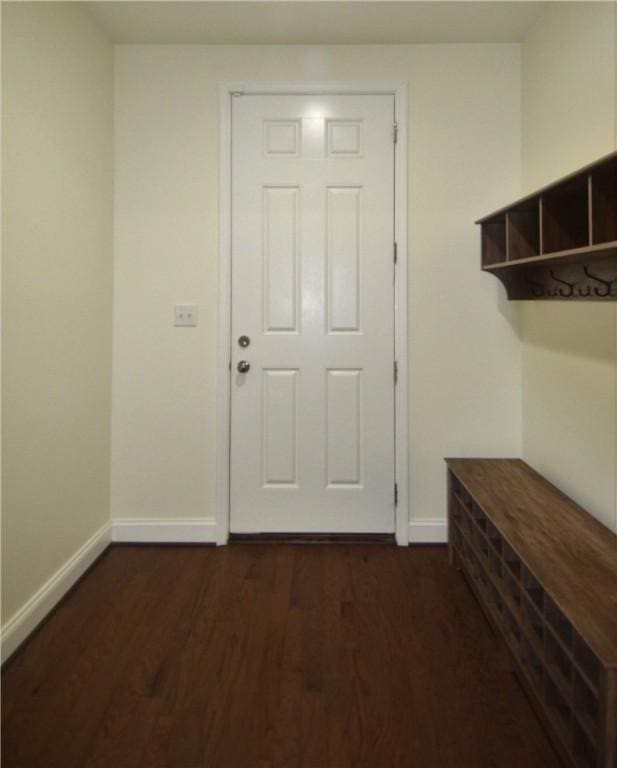 doorway to outside with baseboards and dark wood finished floors