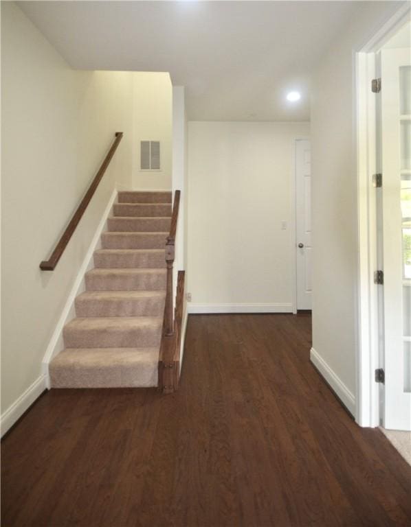 stairs featuring baseboards, recessed lighting, visible vents, and wood finished floors