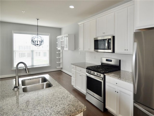 kitchen featuring a sink, a chandelier, white cabinetry, dark wood-style floors, and appliances with stainless steel finishes