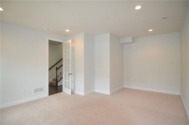 carpeted empty room featuring stairs, baseboards, visible vents, and recessed lighting