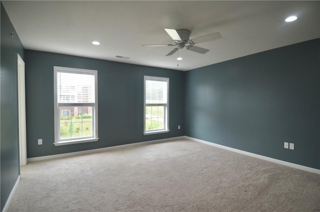 carpeted empty room featuring baseboards, visible vents, recessed lighting, and a ceiling fan