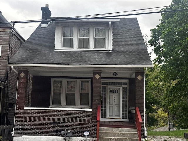 636 Lincoln Ave, East Liberty, PA 15206 - view of front of property featuring covered porch, roof with shingles, a chimney, and brick siding