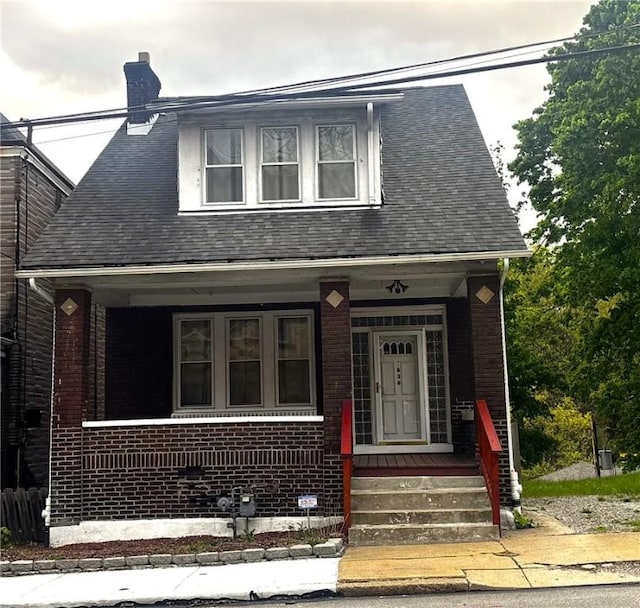 636 Lincoln Ave, East Liberty, PA 15206 - view of front of house with covered porch, brick siding, roof with shingles, and a chimney