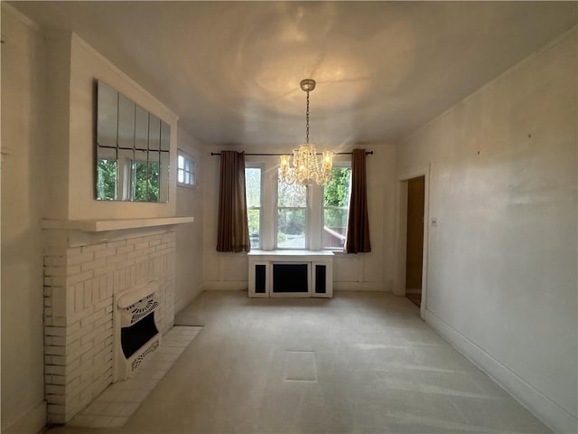 636 Lincoln Ave, East Liberty, PA 15206 - unfurnished dining area featuring light colored carpet, baseboards, a brick fireplace, and a notable chandelier
