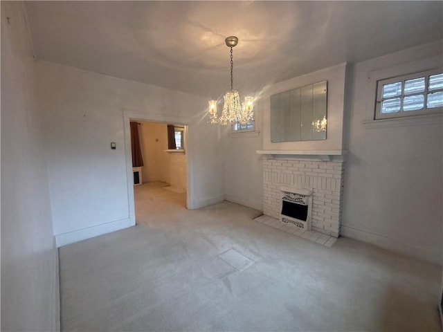 636 Lincoln Ave, East Liberty, PA 15206 - unfurnished living room featuring an inviting chandelier, a brick fireplace, light colored carpet, and baseboards