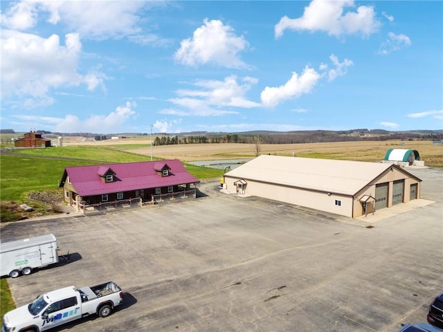 birds eye view of property with a rural view