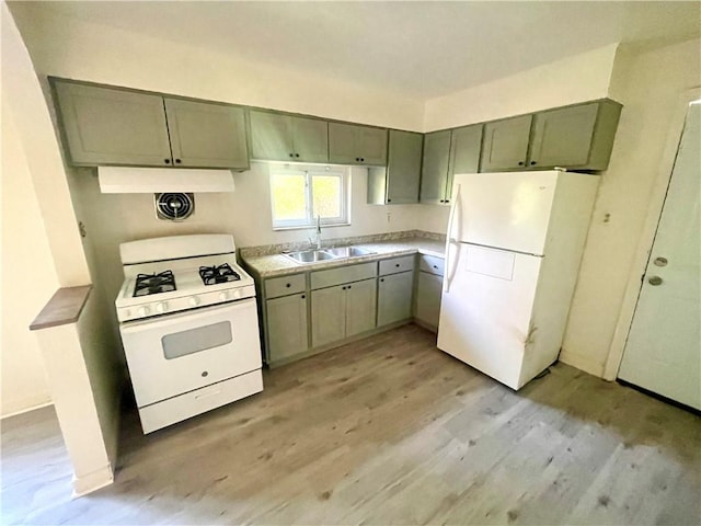 5850 Heberton Dr, Penn Hills, PA 15147 - kitchen with white appliances, a sink, light wood-style floors, range hood, and light countertops