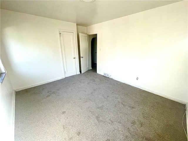 carpeted empty room with baseboards and visible vents