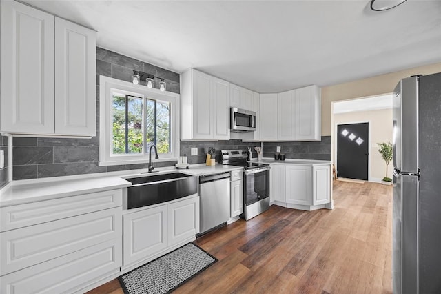 54 Devils Den Rd, Hanover Twp Wsh, PA 15021 - kitchen with a sink, backsplash, light countertops, white cabinets, and appliances with stainless steel finishes