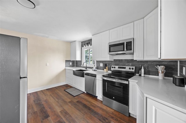 54 Devils Den Rd, Hanover Twp Wsh, PA 15021 - kitchen with a sink, white cabinetry, backsplash, light countertops, and appliances with stainless steel finishes