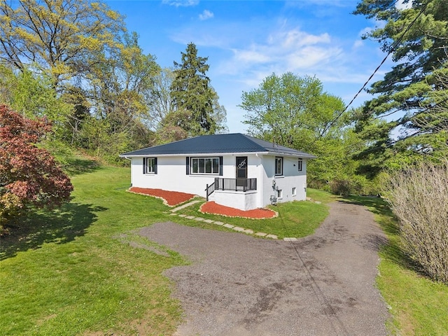 54 Devils Den Rd, Hanover Twp Wsh, PA 15021 - view of front of property with dirt driveway, a front yard, stucco siding, and metal roof
