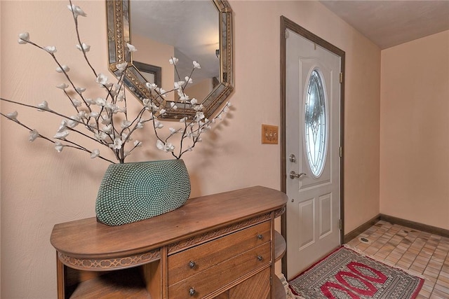 foyer featuring baseboards