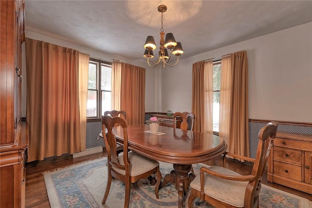 dining room with a notable chandelier and wood finished floors