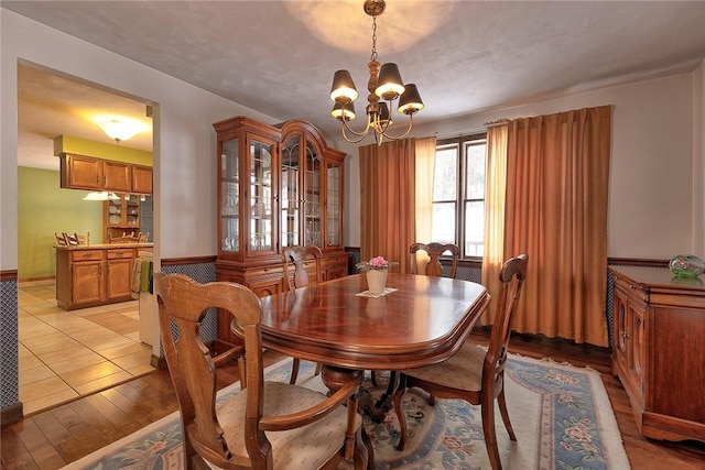 dining room featuring a notable chandelier and light wood-style flooring