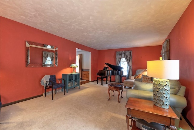 living area featuring baseboards, carpet flooring, and a textured ceiling