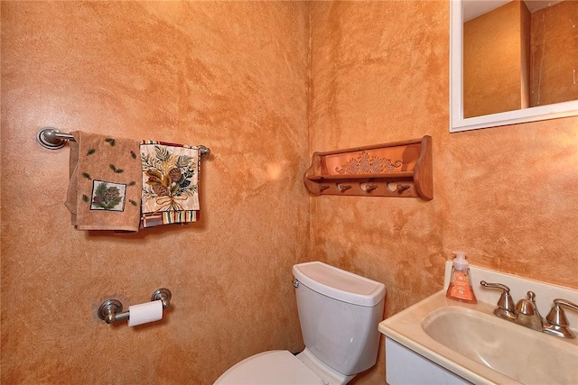 half bath featuring toilet and vanity