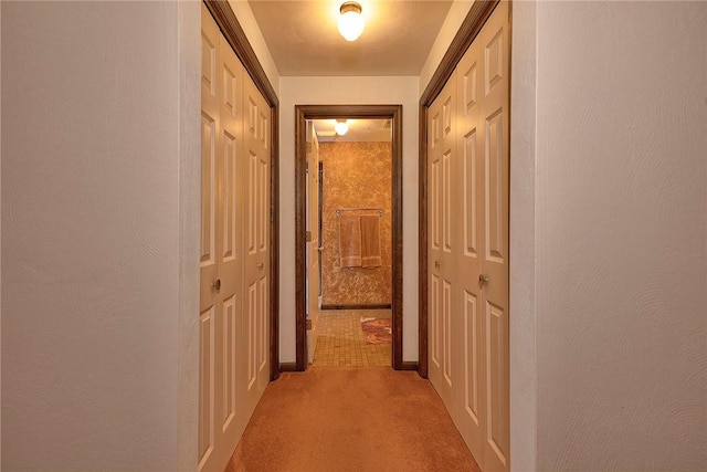hallway with light carpet and baseboards