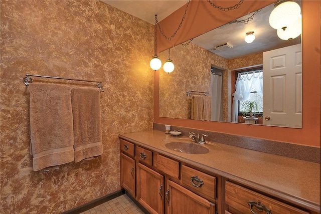 bathroom with tile patterned floors, visible vents, and vanity