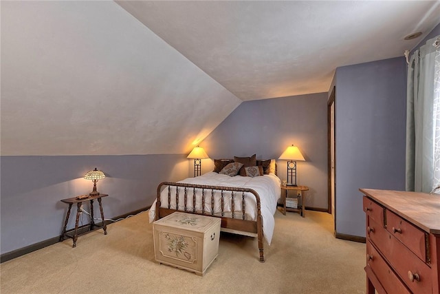 bedroom with baseboards, light colored carpet, and vaulted ceiling