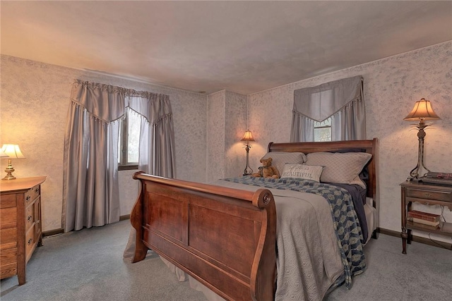 bedroom with baseboards, wallpapered walls, and light colored carpet