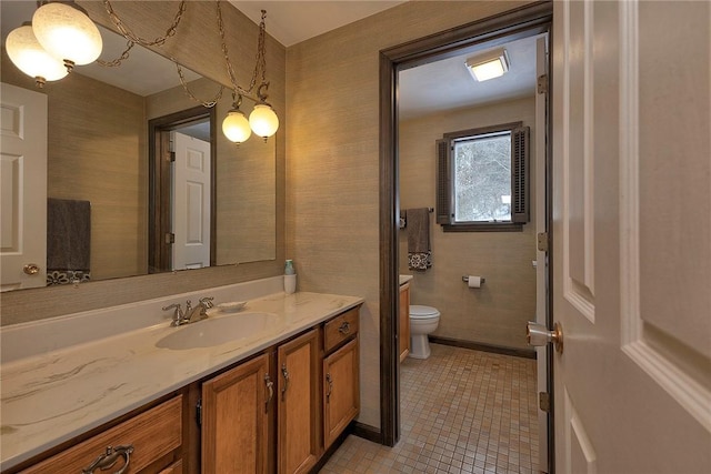 bathroom featuring toilet, tile patterned flooring, and vanity