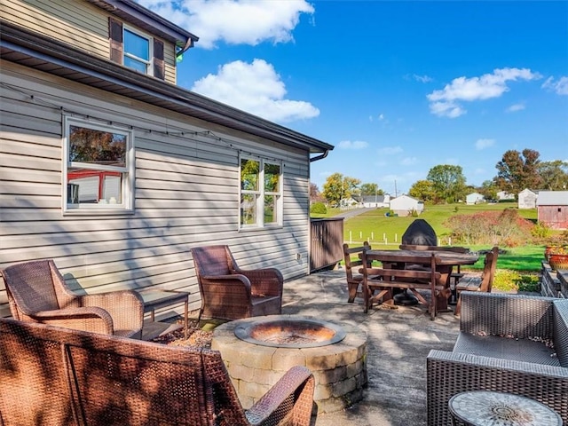 view of patio with an outdoor fire pit and outdoor dining area