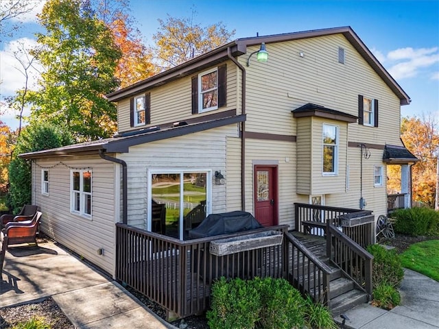 rear view of house featuring a deck