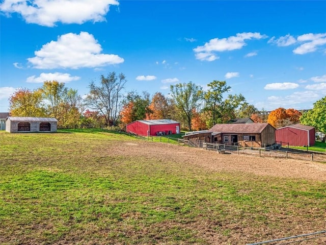 view of yard with a pole building, an outbuilding, and an exterior structure
