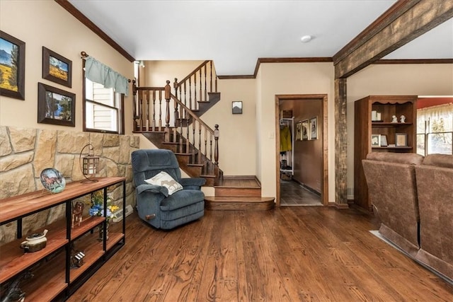 entryway with crown molding, wood finished floors, baseboards, and stairs