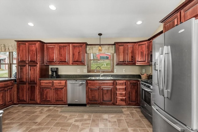 kitchen with a sink, dark countertops, stainless steel appliances, decorative light fixtures, and recessed lighting