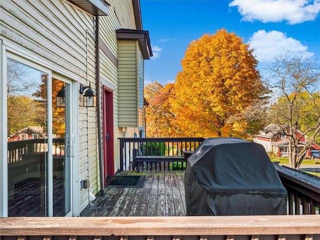 wooden terrace featuring area for grilling