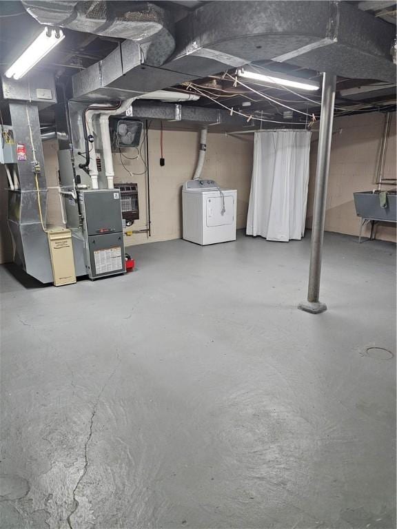 unfinished basement with separate washer and dryer and heating unit