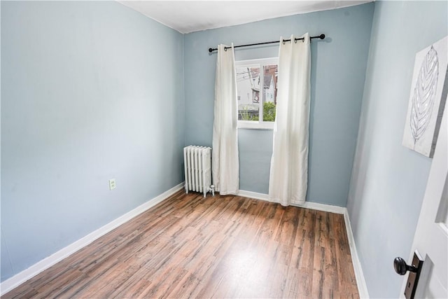 1318 Louise St, Munhall, PA 15120 - empty room with radiator, wood finished floors, and baseboards