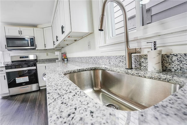 1318 Louise St, Munhall, PA 15120 - kitchen featuring appliances with stainless steel finishes, a sink, white cabinetry, and light stone counters