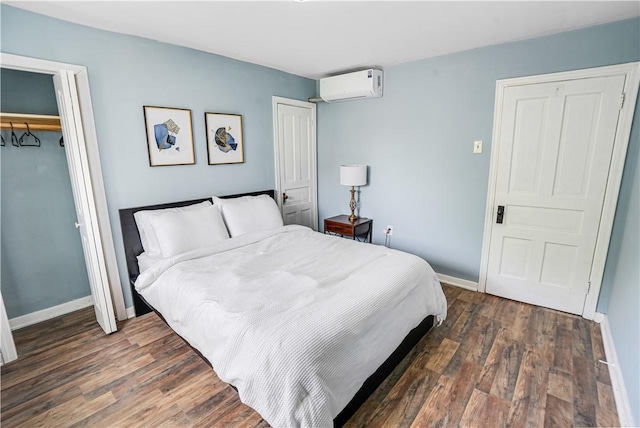 1318 Louise St, Munhall, PA 15120 - bedroom with a wall unit AC, dark wood-type flooring, a closet, and baseboards