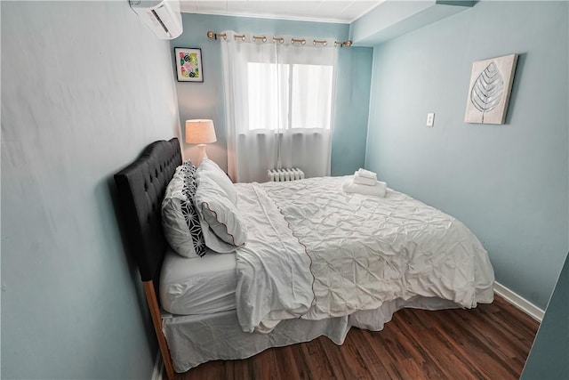 1318 Louise St, Munhall, PA 15120 - bedroom with a wall mounted air conditioner, wood finished floors, radiator heating unit, and baseboards