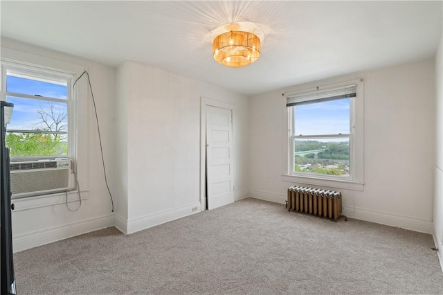 unfurnished bedroom with radiator, baseboards, and carpet flooring