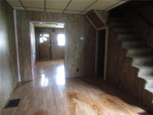 interior space with stairway, light wood finished floors, and visible vents