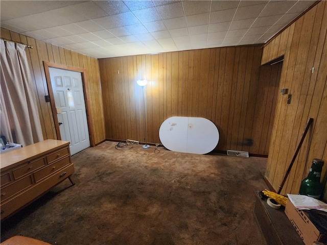 172 49th St, Lawrenceville, PA 15201 - bedroom with baseboards, dark carpet, wooden walls, and visible vents