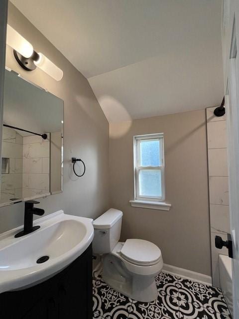 bathroom featuring toilet, vanity, tile patterned floors, vaulted ceiling, and bathing tub / shower combination